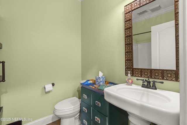 bathroom with baseboards, a sink, and toilet