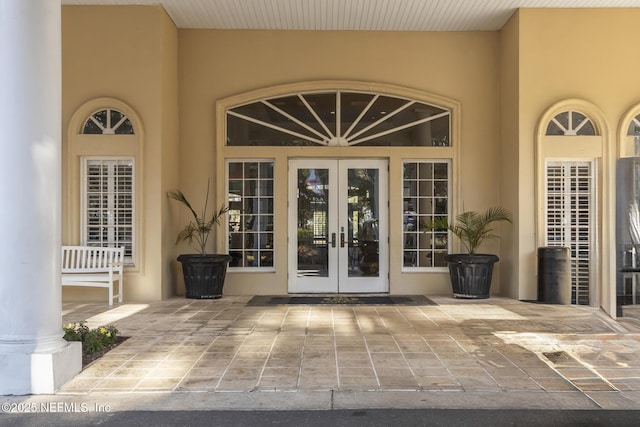 entrance to property with stucco siding and french doors