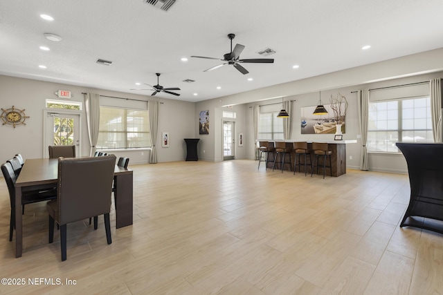 dining space featuring recessed lighting, visible vents, plenty of natural light, and light wood finished floors