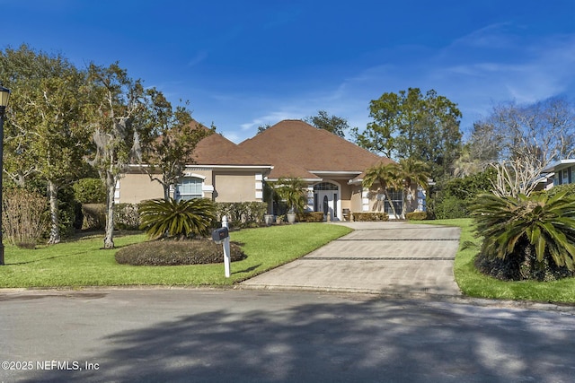 view of front facade with a front lawn and stucco siding