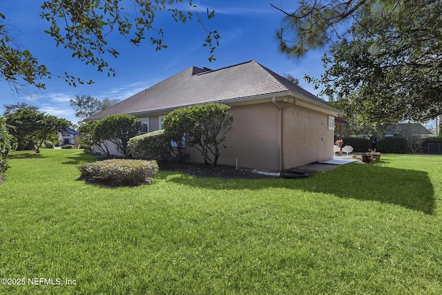 view of home's exterior with a yard and stucco siding