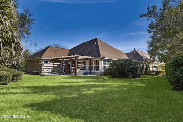 rear view of property with a yard and a patio area