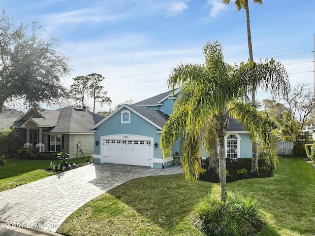 view of front facade with a garage and a front yard