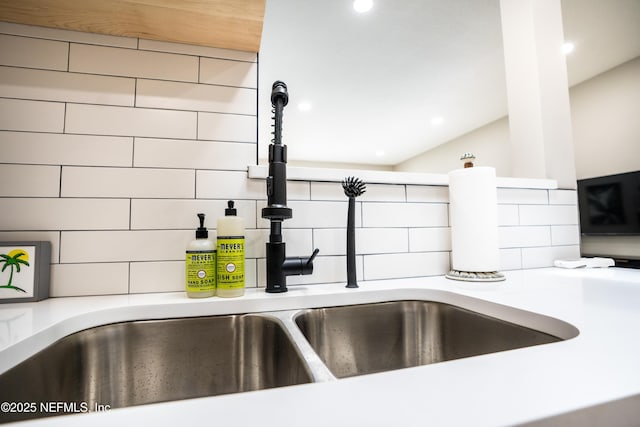 interior details featuring tasteful backsplash and sink