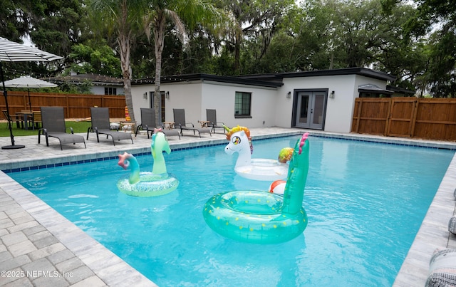 view of pool with a patio and french doors