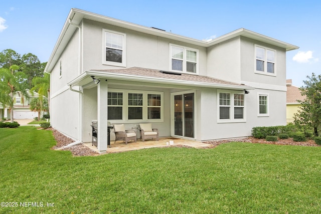 rear view of property featuring a yard and a patio