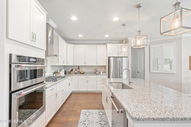 kitchen featuring sink, an island with sink, white cabinets, and appliances with stainless steel finishes