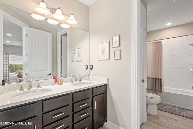 full bathroom with shower / bath combination with curtain, vanity, and toilet