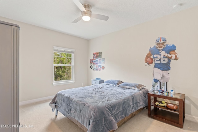 carpeted bedroom featuring a textured ceiling and ceiling fan