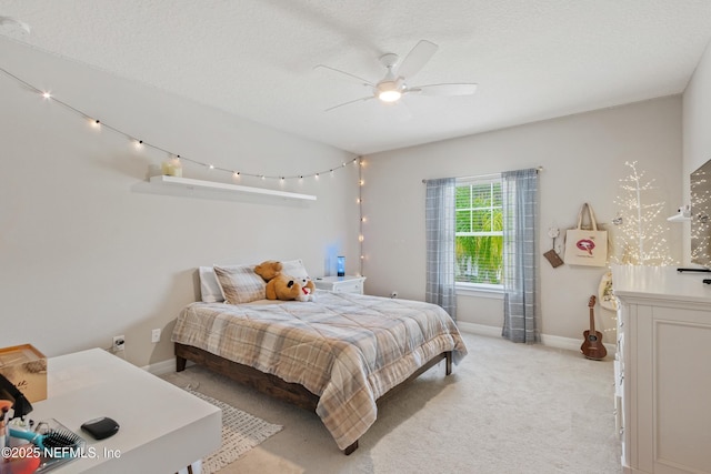 carpeted bedroom featuring a textured ceiling and ceiling fan