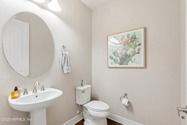 bathroom featuring toilet and sink