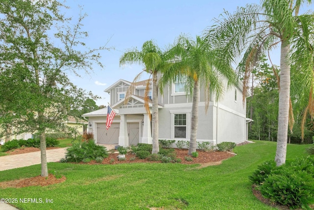 view of front facade featuring a garage and a front lawn