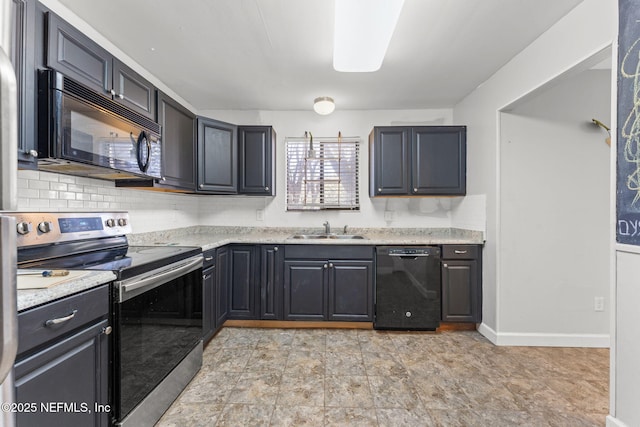 kitchen with light stone counters, sink, decorative backsplash, and black appliances