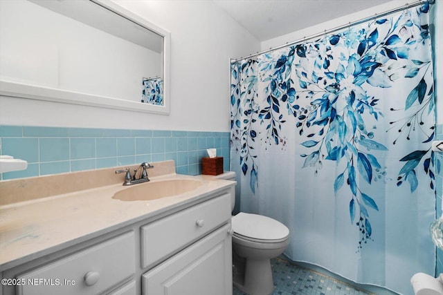 bathroom featuring vanity, tile walls, curtained shower, and toilet