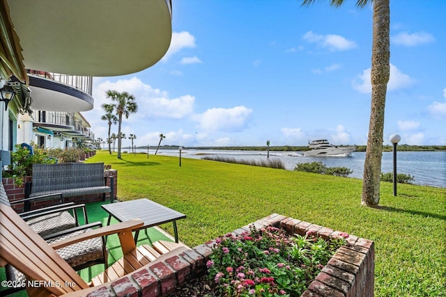 view of yard featuring a balcony and a water view