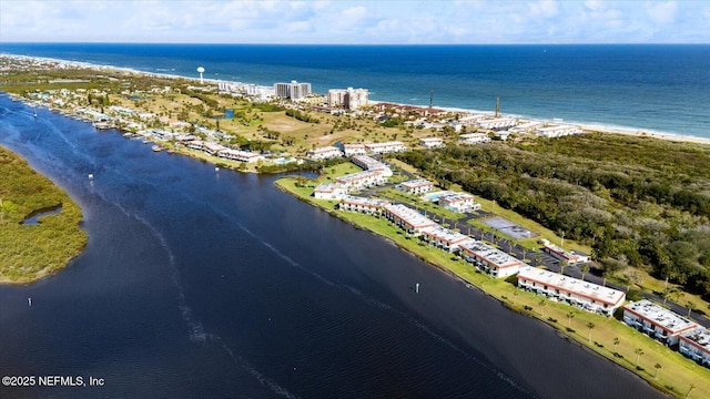 drone / aerial view featuring a water view and a beach view