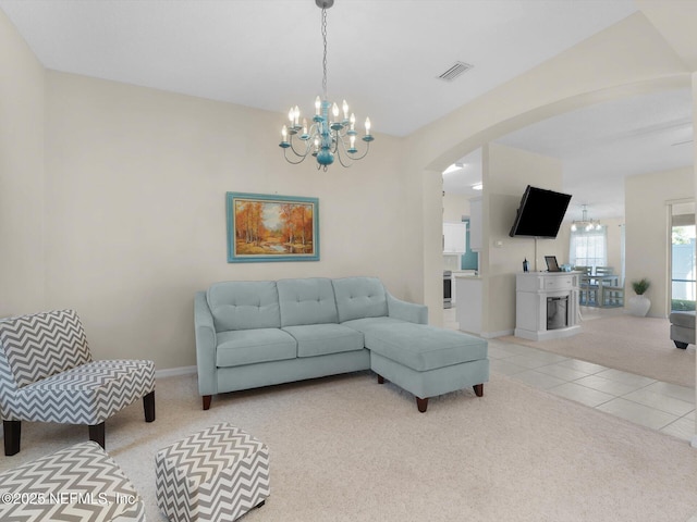 living room featuring light carpet and an inviting chandelier