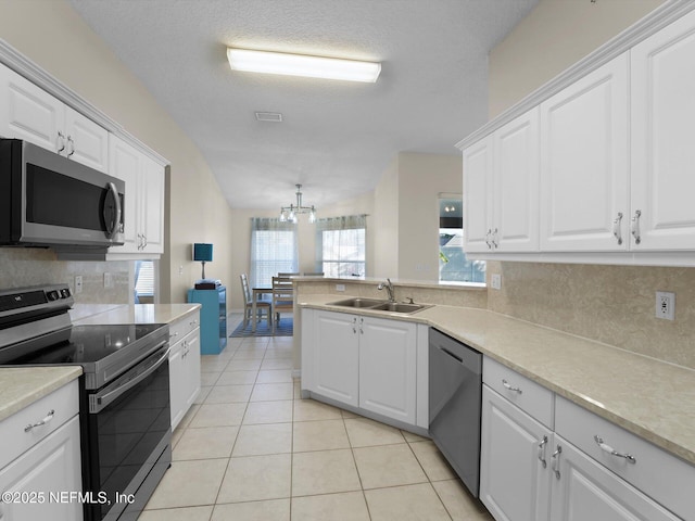 kitchen with stainless steel appliances, sink, and white cabinets