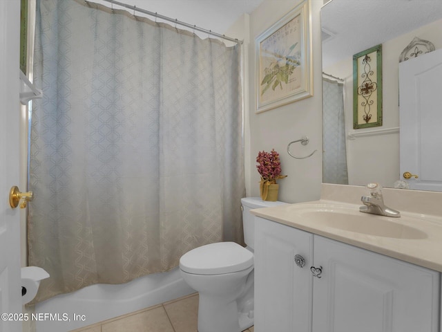 bathroom with tile patterned flooring, vanity, and toilet