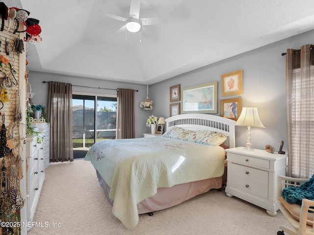 bedroom featuring lofted ceiling, ceiling fan, access to exterior, light carpet, and a raised ceiling