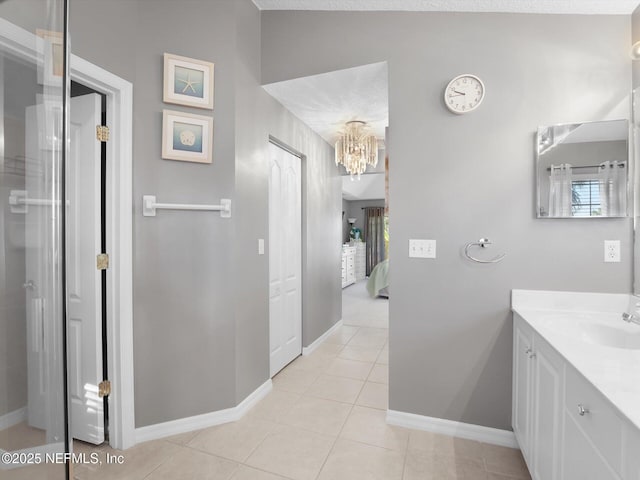 bathroom featuring vanity, lofted ceiling, a healthy amount of sunlight, and tile patterned floors