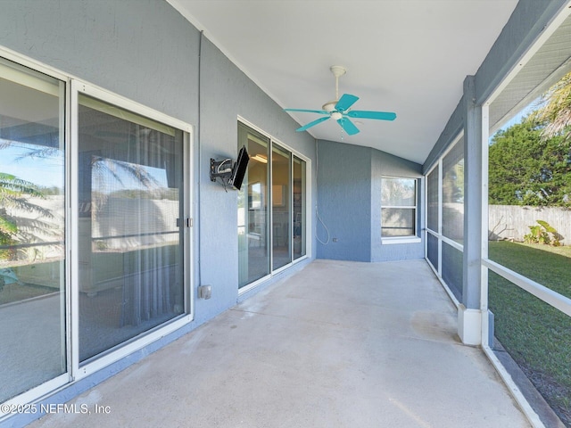 unfurnished sunroom featuring vaulted ceiling and ceiling fan