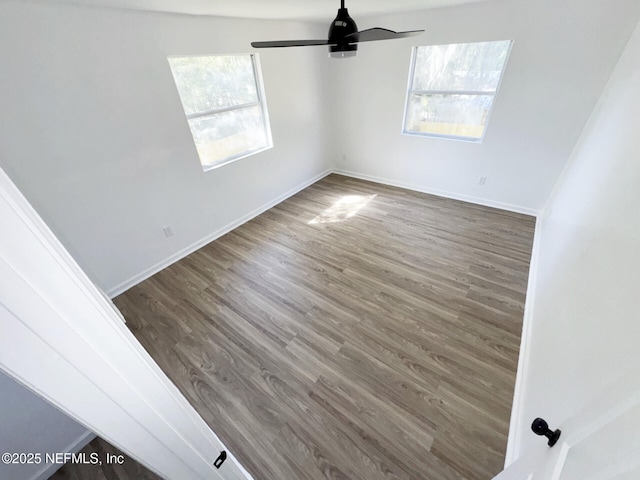 unfurnished room featuring dark hardwood / wood-style flooring and ceiling fan