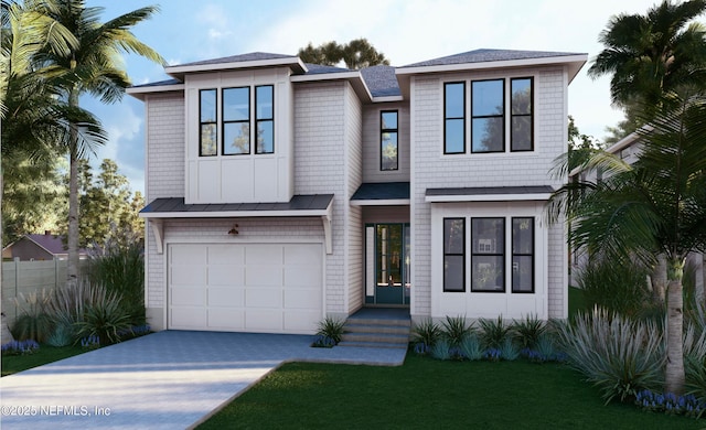 view of front of house featuring a garage and a front lawn