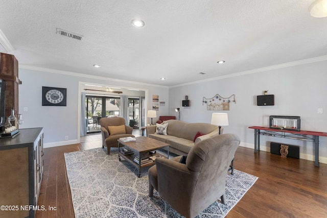 living room featuring crown molding, a textured ceiling, and dark hardwood / wood-style flooring