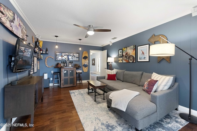 living room featuring crown molding, dark wood-type flooring, and ceiling fan