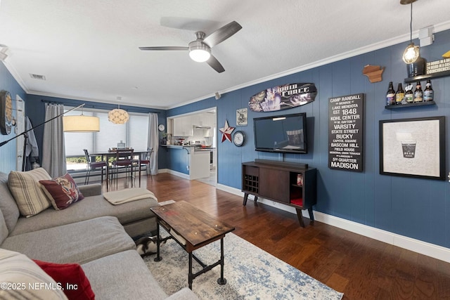 living room featuring crown molding, ceiling fan, dark hardwood / wood-style floors, and a textured ceiling