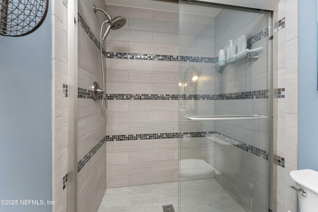 bathroom featuring walk in shower and toilet