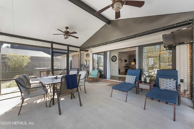 sunroom / solarium featuring lofted ceiling with beams and ceiling fan