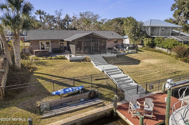 rear view of property with a patio, a jacuzzi, a sunroom, and a lawn