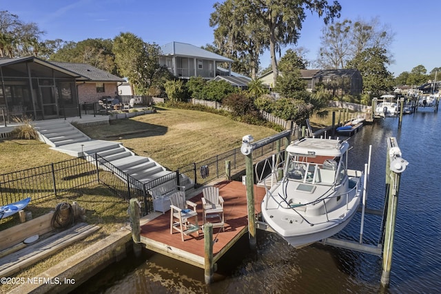 view of dock featuring a water view and a lawn