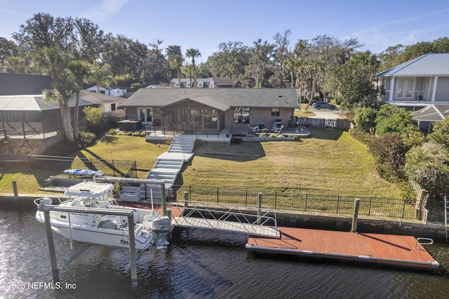 dock area featuring a lawn and a water view