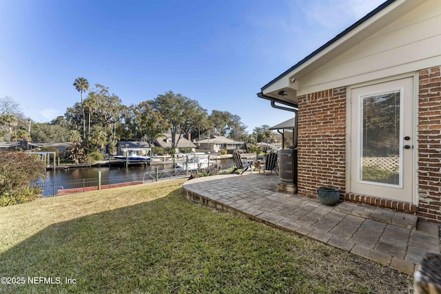 view of yard featuring a patio area and a water view