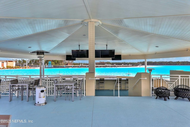 view of pool featuring a water view