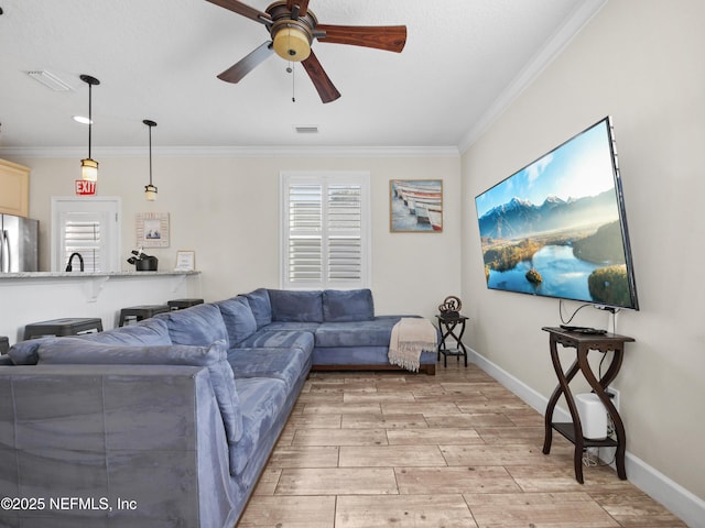 living room with crown molding and ceiling fan