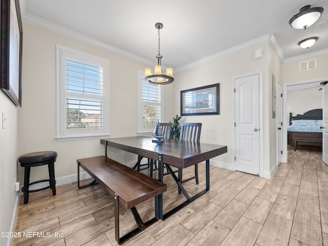 dining area featuring crown molding and ceiling fan