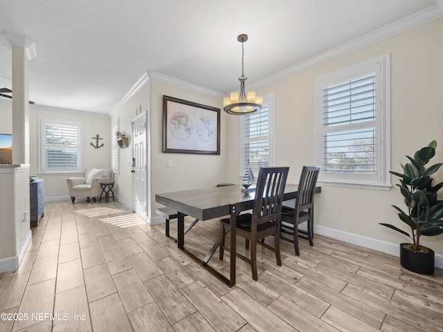 dining space featuring crown molding and a chandelier