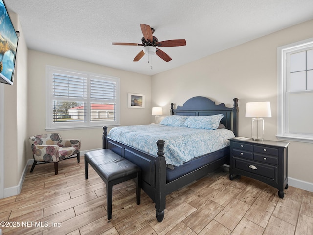 bedroom with ceiling fan and a textured ceiling