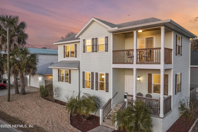 view of front of house featuring a balcony