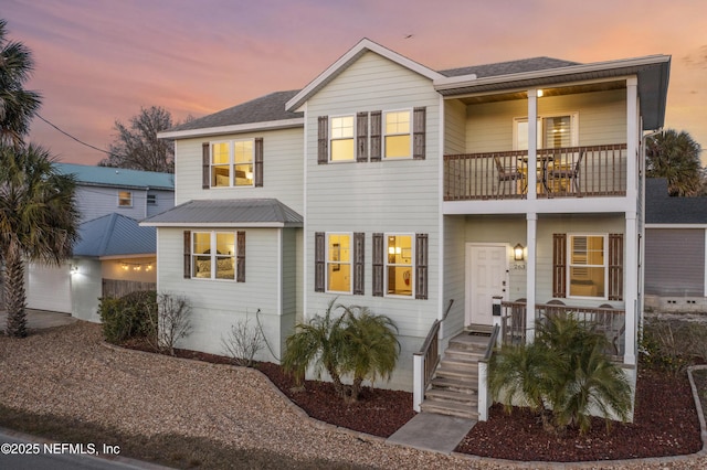 view of front of home featuring a balcony