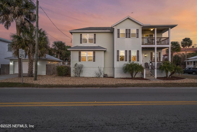 view of property with a garage and a balcony