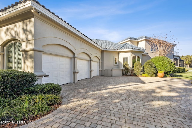 mediterranean / spanish-style home with a garage