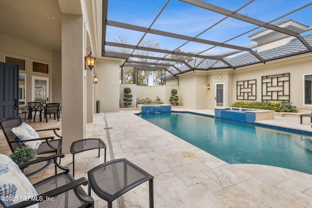 view of swimming pool featuring an in ground hot tub, a patio, and glass enclosure