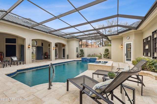 view of swimming pool featuring an in ground hot tub, glass enclosure, and a patio