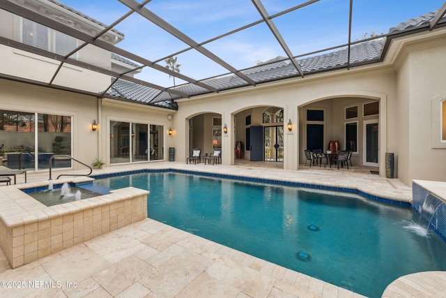 view of swimming pool with pool water feature, a hot tub, a patio, and a lanai