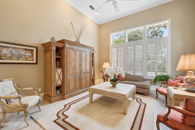 living area with a high ceiling, ornamental molding, ceiling fan, and light tile patterned flooring